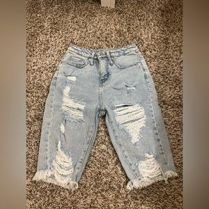 Ripped jeans shorts that stop at the knee